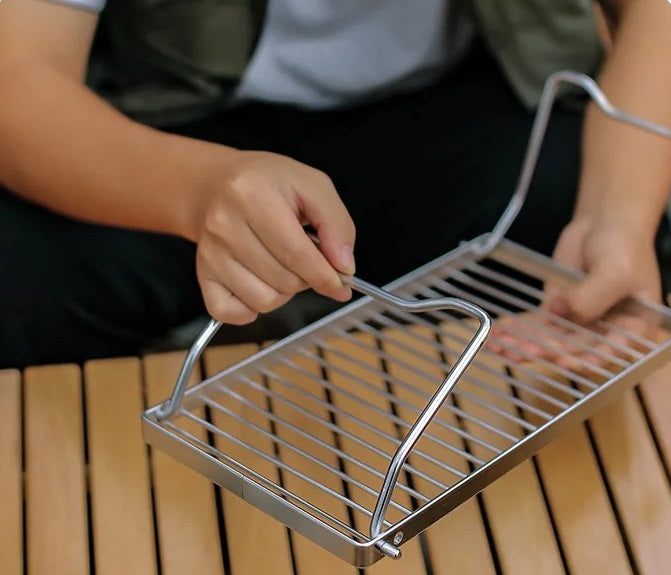 man-folding-a-grill-stand